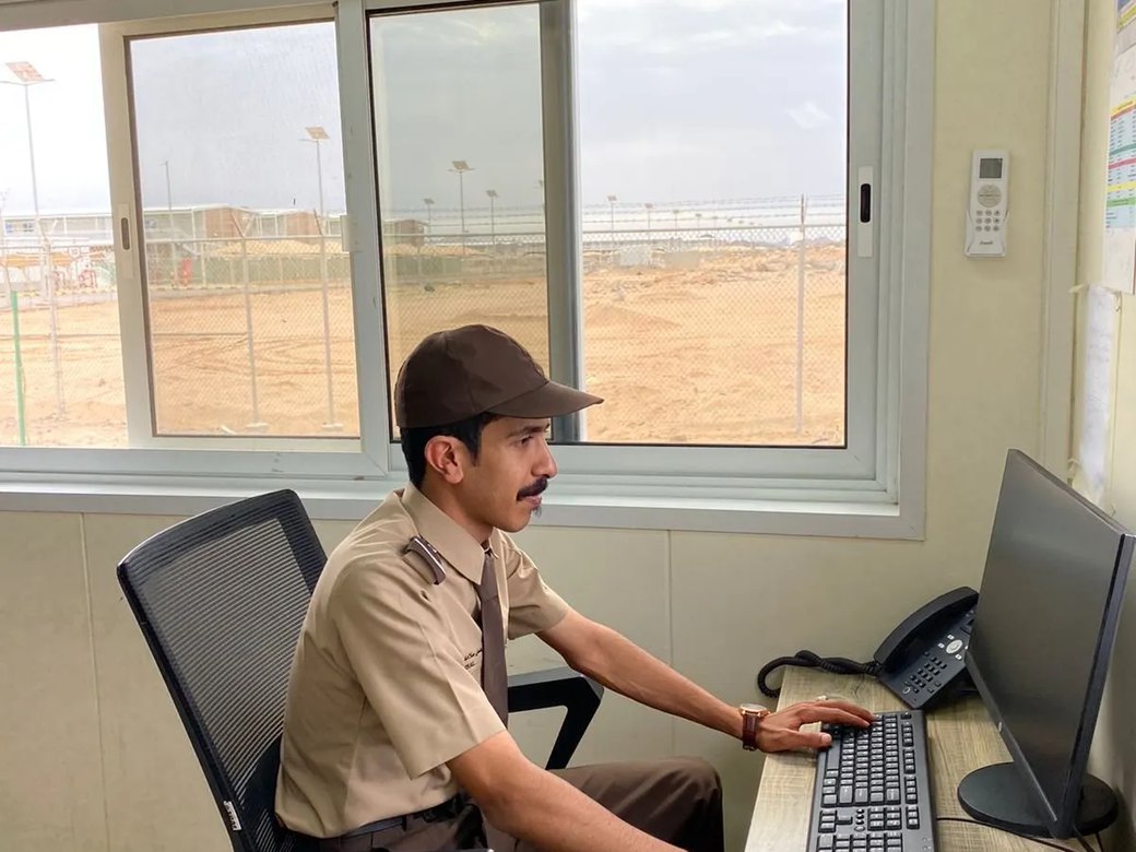 Security officer monitoring and reporting from a site office